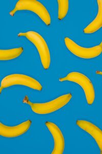 yellow banana fruits on blue surface